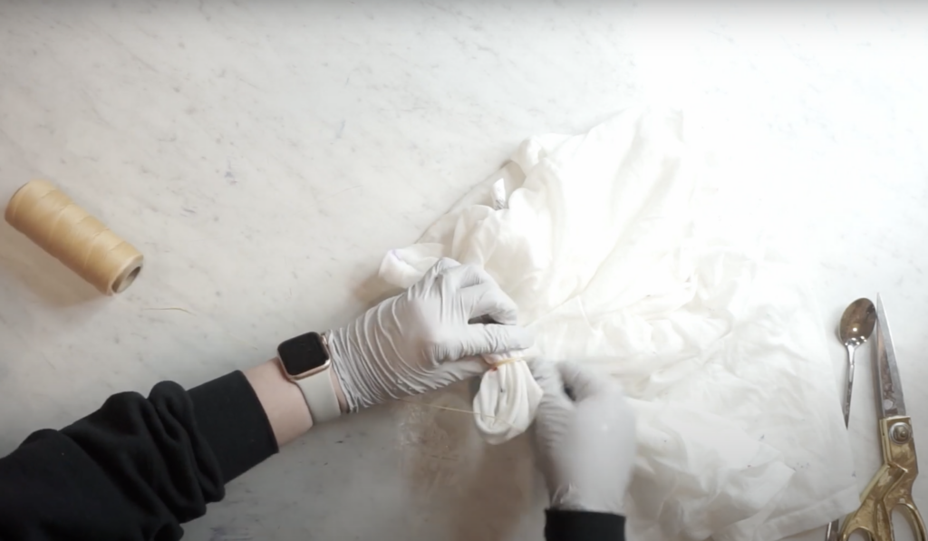 Tying a heart shirt with sinew for a clean heart pattern in ice dye